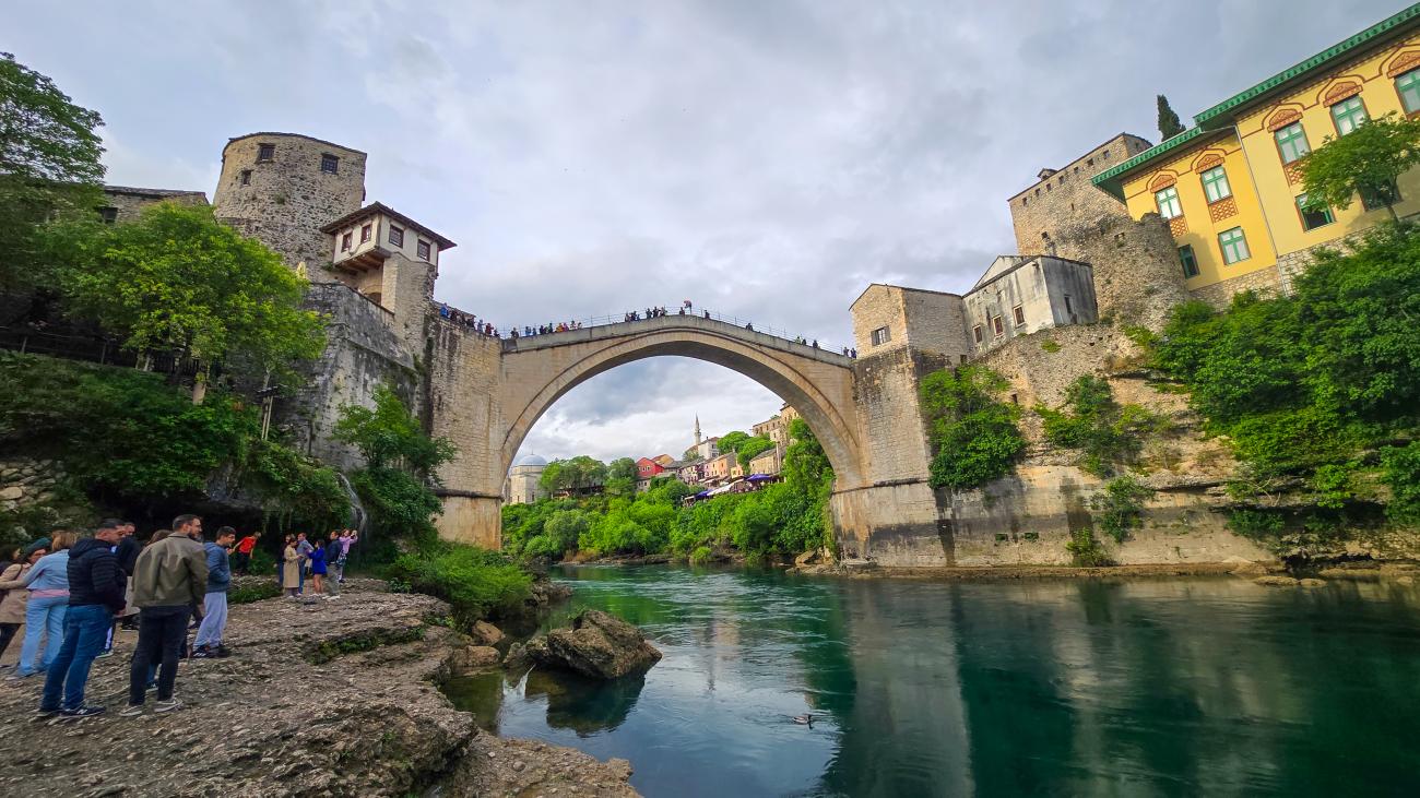 The iconic Stari Most old bridge arching over the emerald Neretva River in Mostar, Bosnia and Herzegovina.