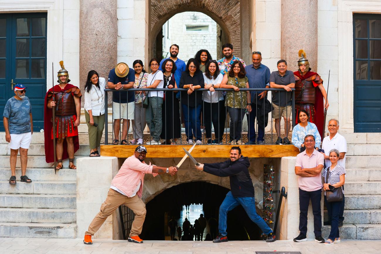 Tour group posing with costumed Roman soldiers at Diocletian's Palace in Split, Croatia