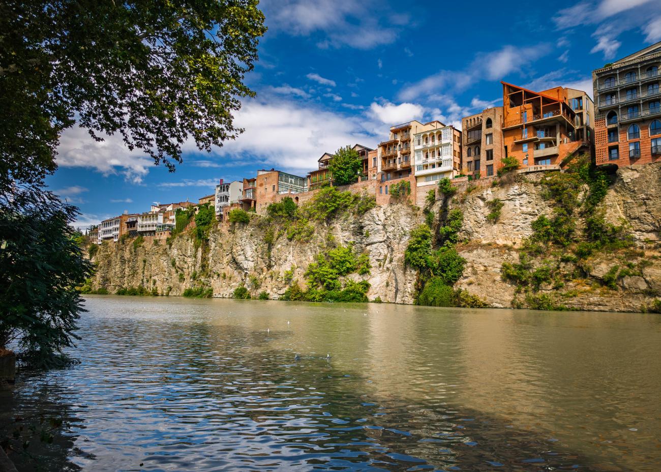 Colorful old town houses perched on cliffs above the Mtkvari River in Tbilisi, Georgia.