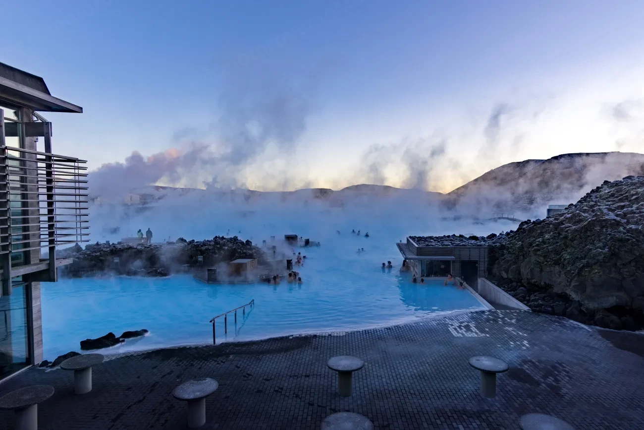 Steam rising off the milky blue geothermal water of the Blue Lagoon