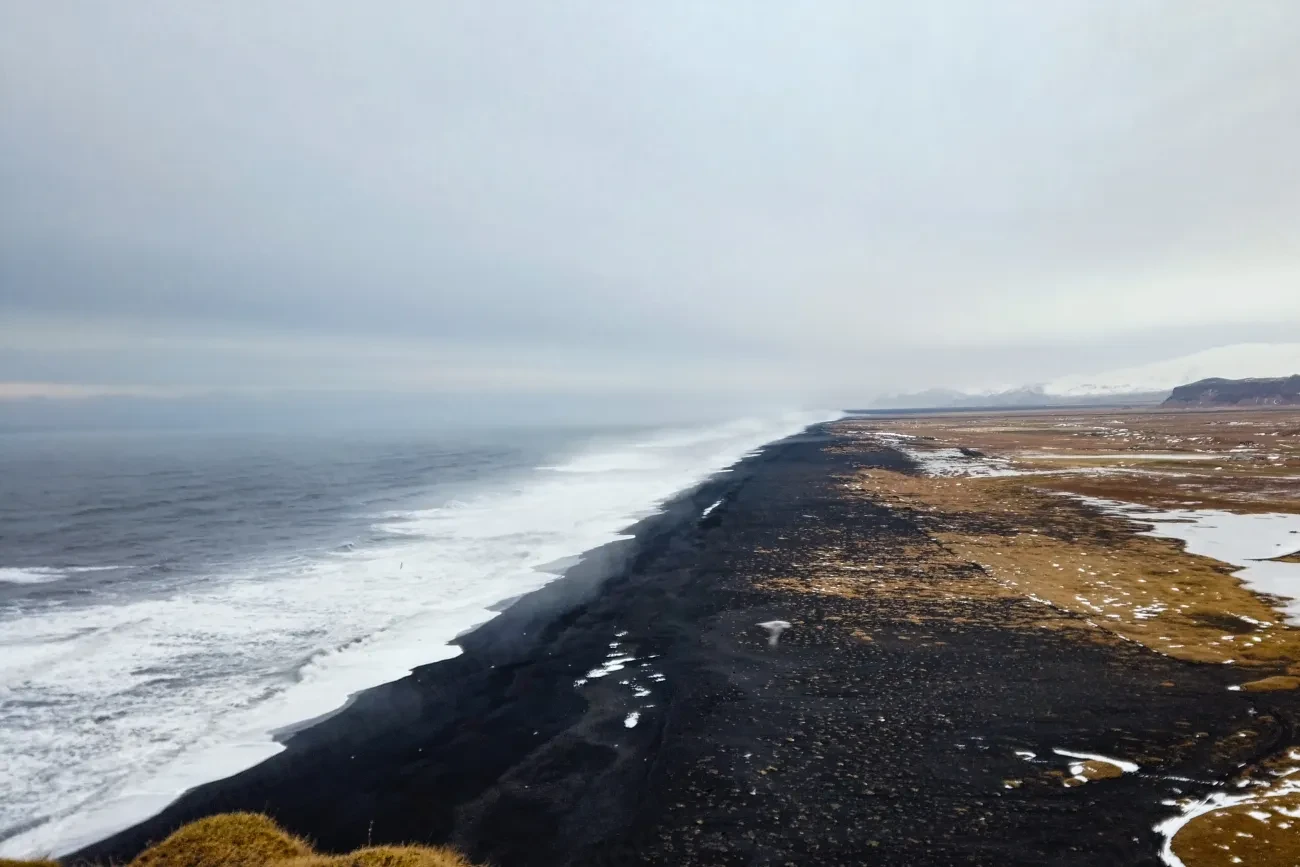 The long black sand coastline seen from Dyrhólaey on the south coast of Iceland