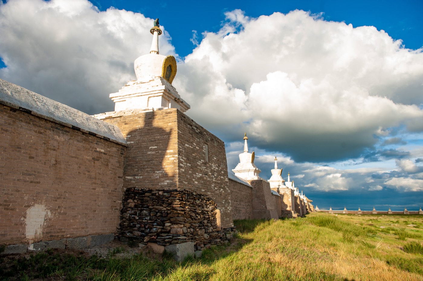 The great white stupa and temple buildings of Erdene Zuu Monastery under a clear blue sky