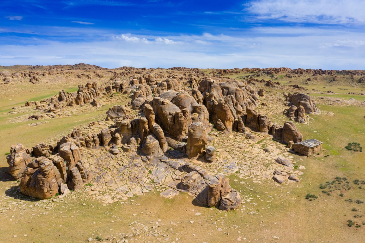 Aerial view of striking granite rock formations rising from the open Mongolian steppe