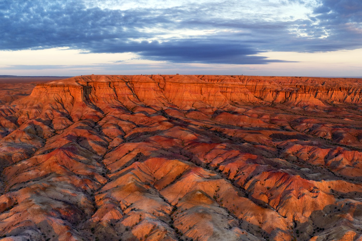 Dramatic eroded cliffs of Tsagaan Suvarga canyon under a moody dusk sky in the Gobi Desert