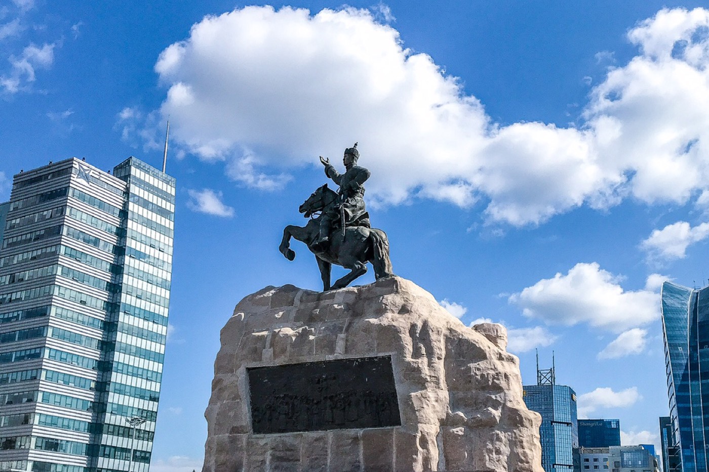 An equestrian statue in central Ulaanbaatar framed by the city's glass skyscrapers