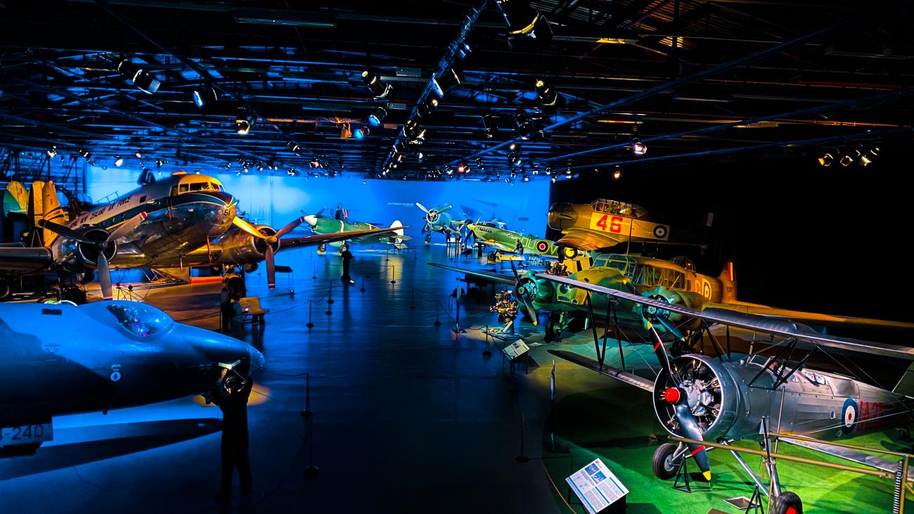 Collection of vintage military aircraft on display inside the New Zealand Air Force Museum.