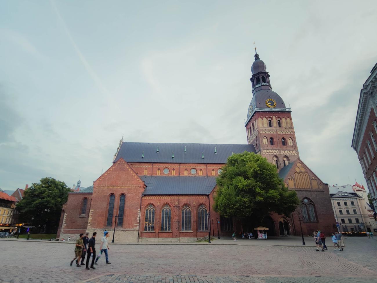Riga Cathedral with its red brick facade and clock tower in the old town square, Latvia.
