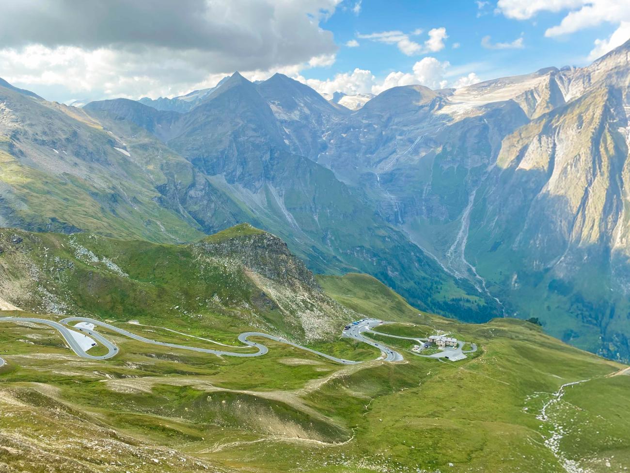Panoramic view of the Grossglockner High Alpine Road switchbacks winding through green mountain valleys in Austria.